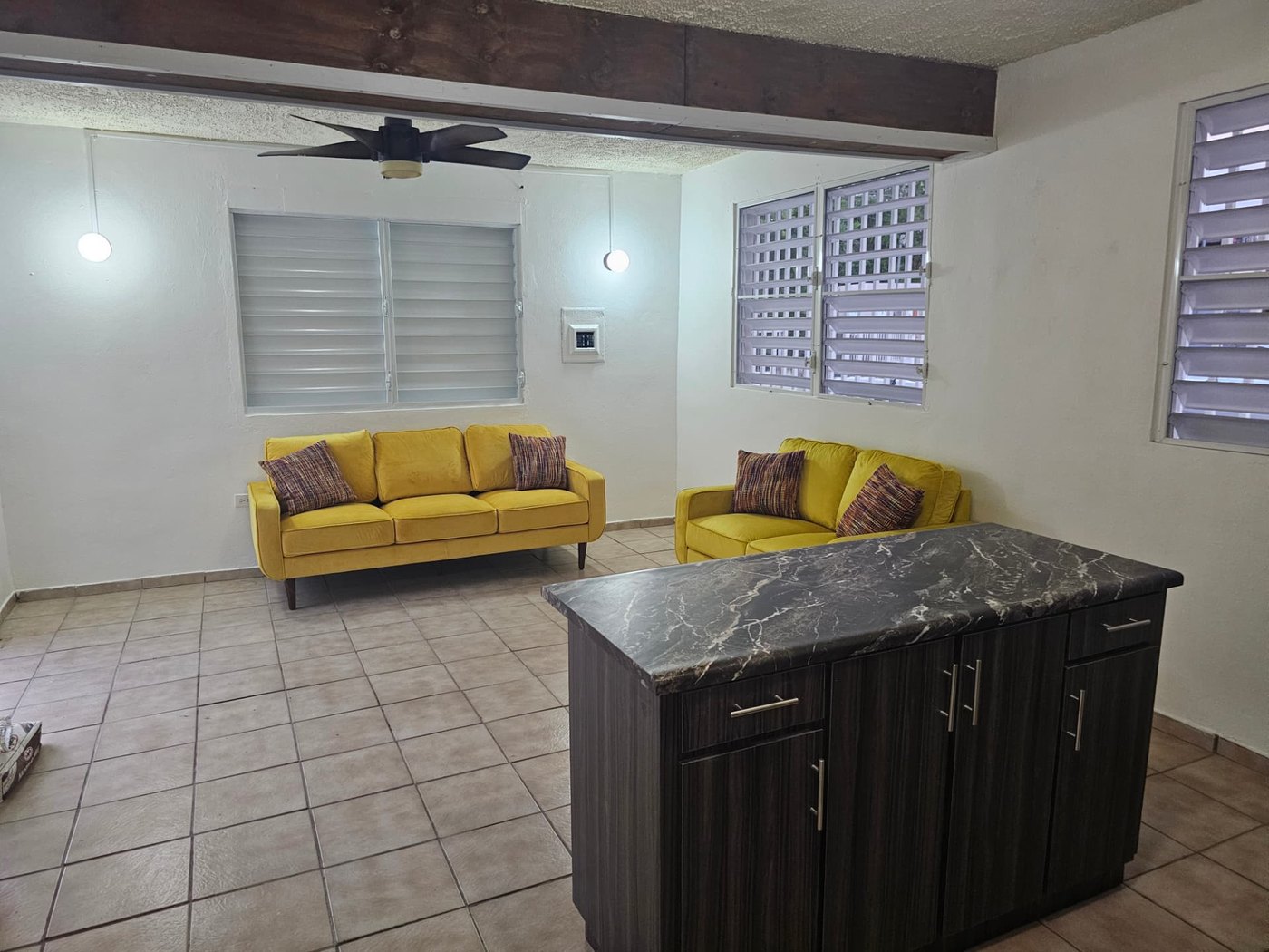 Renovated open-plan living and kitchen area of a single-family home in Puerto Rico